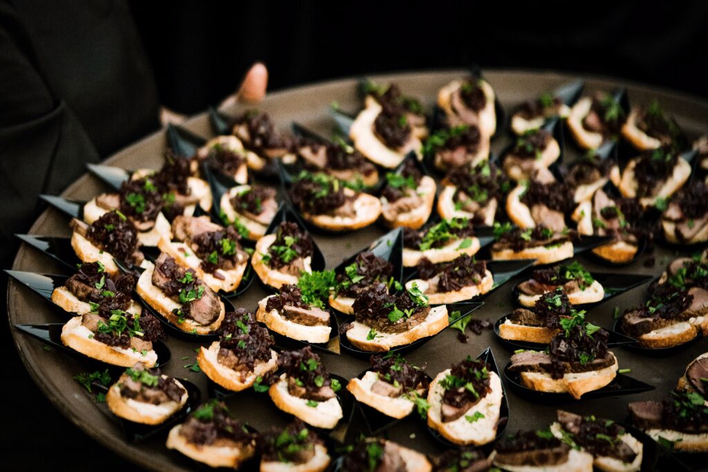 Tray of passed crostini hors d’oeuvres.